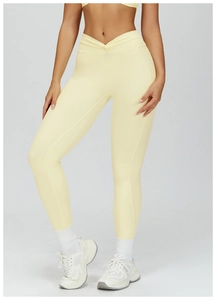 Detail of high waist yoga pants featuring a unique V-shaped cross waistband design