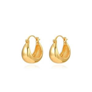Detail of gold teardrop earrings with polished finish and granular inner texture