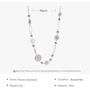 Detail of bohemian silver flower body chain with shells and pearls showing 94cm length