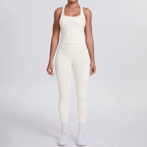 Detail of white racerback yoga top and high waist leggings with side pockets