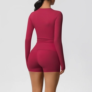 Back view of solid burgundy long-sleeve yoga top and tight shorts athletic set