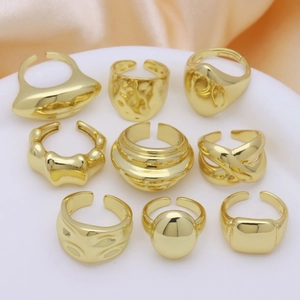 Set of nine minimalist 18k gold plated copper rings with geometric and woven textures