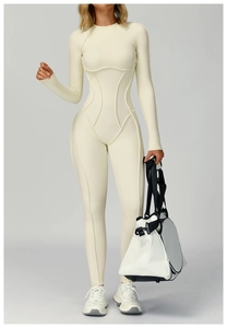 Detail of cream white ribbed yoga bodysuit featuring shaping seams and high elasticity