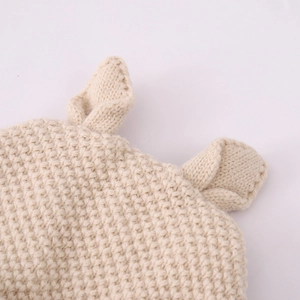Detailed close-up of cream knit baby hat showing soft 3D honeycomb weave and cute ears