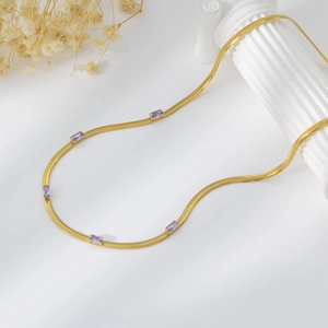 Detail of gold snake chain necklace featuring five rectangular purple zircon stones