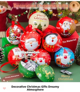 Close-up of festive tin Christmas ball gift boxes with various holiday character patterns