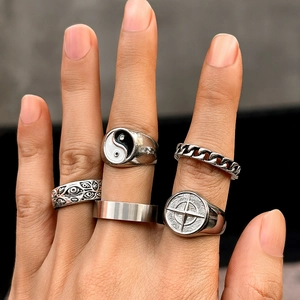 Macro view of five-piece silver ring set featuring tai chi and star compass motifs