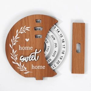 Detail of wooden perpetual calendar with rotatable dials and home sweet home text