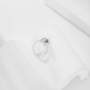 Macro detail of a silver S925 geometric ring with a sparkling round solitaire gemstone