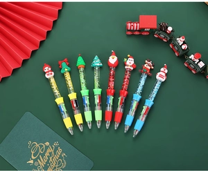 Close-up of Christmas 4-color ballpoint pens with Santa and snowman motifs in a festive layout