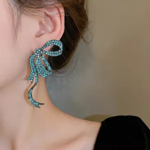 Elegant long bowknot earrings with turquoise rhinestones and silver needle pins