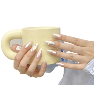 Luxurious handmade almond press-on nails in pearl white with shell and stone accents
