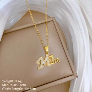 Detail of gold Mom heart pendant with sparkling crystals on elegant white silk and jewelry box