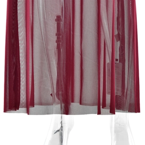 Detailed view of red sheer mesh fabric hem with elegant draped ruffles and texture