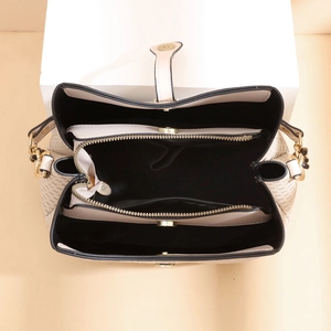 Beige patterned bucket bag with multiple interior compartments and zipper pocket