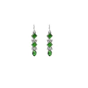 Close-up of vintage silver earrings with green square and teardrop crystal pendants
