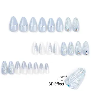 Almond press-on nails with light blue 3D shell texture, silver glitter and rhinestones