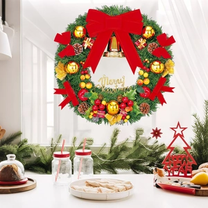 Christmas wreath with red velvet bow, gold bells and Merry Christmas sign decoration