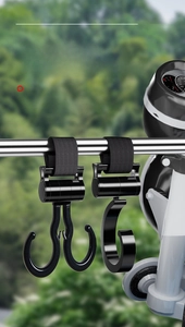 Detail view of universal black nylon strap hook for scooters and bicycles on metal bar
