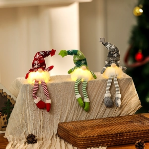 Three glowing Christmas gnomes in red, green, and grey with warm LED lights and snowflake hats