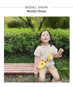 Cute knitted giraffe shoulder bag for girls shown during outdoor model photo shoot