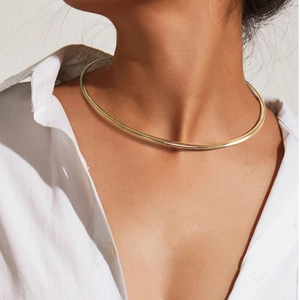 Minimalist 18K gold plated stainless steel torque necklace shown on professional model