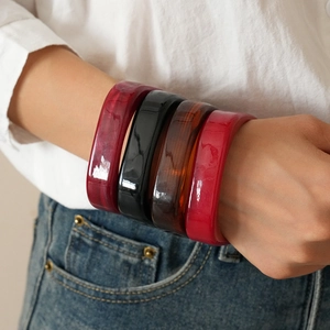 Set of 4 geometric resin bangles in marble red, black, amber brown, and vibrant red