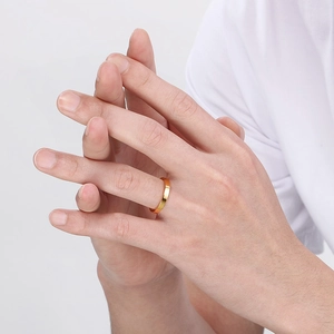 Minimalist 3mm gold stainless steel ring worn on hand with a sleek polished finish