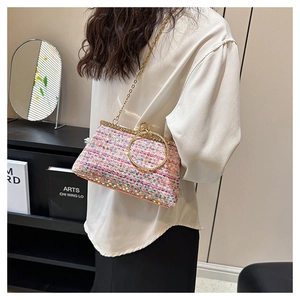 Close-up of pink sequin tweed evening bag with gold ring handle and chain strap detail