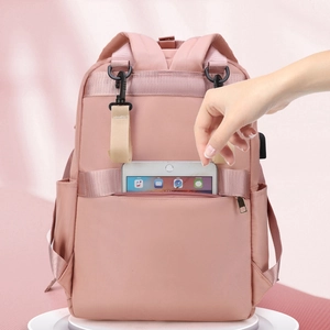 Pink waterproof diaper backpack with luggage strap, USB port, and anti-theft back pocket