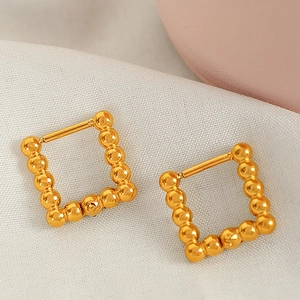 Minimalist gold beaded square hoop earrings featuring a vintage geometric design on fabric