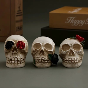 Three gothic resin skull figurines with roses and LED lights for Halloween decoration