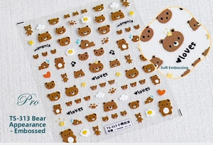 Macro detail showing 5D cute brown bear embossed nail art stickers with 3D star elements