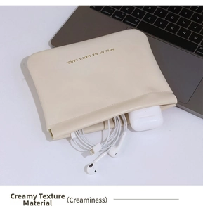 Close-up of cream PU leather gadget pouch with squeeze spring closure for cables