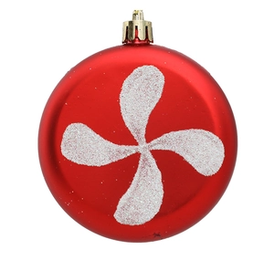 Detail of red Christmas ball ornament with white glitter patterns and gold hanger cap
