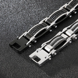 Close-up of black and silver stainless steel cable bracelets with folding clasps