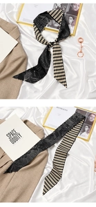 Detail of double-sided silk scarf with geometric patterns and elegant lettering