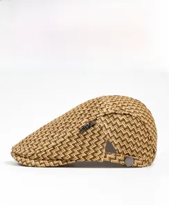 Detail of breathable straw flat cap with wave texture and metallic side emblem buckle