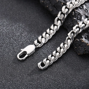 Macro shot of silver stainless steel curb chain necklace with secure lobster clasp