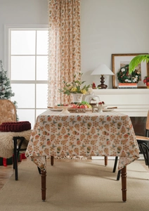 Detail view of cotton linen tablecloth with Christmas gingerbread man and tree pattern