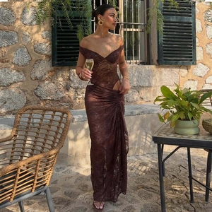 Detail of dark brown lace maxi dress featuring backless cut-out and sheer fabric texture