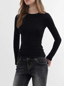 Close-up of slim fit black long sleeve crew neck top with soft knitted texture