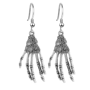 Close-up of vintage silver skeleton hand drop earrings with punk gothic bone textures