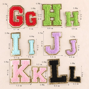 Detail of chenille letter patches G-L with gold glitter borders and sizes