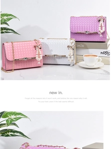 Three woven shoulder bags in pink white and purple with pearl bow charms and gold chains