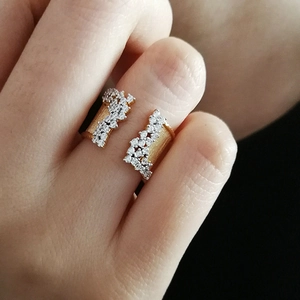 Detailed view of adjustable gold-plated ring featuring brushed texture and micro-pave stones