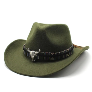 Detail of dark green western cowboy felt hat with ethnic band and metal bull skull ornament