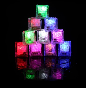 Colorful LED glowing ice cubes stacked in pyramid shape with vibrant light on black background