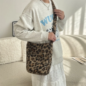 Detail of leopard print faux fur shoulder bag showing soft plush texture and large capacity