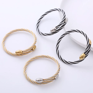 Twisted cable wire bracelet set in silver and gold plating with polished ball ends